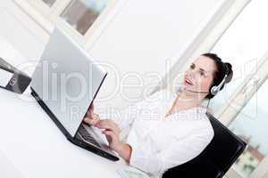 smiling young female callcenter agent with headset