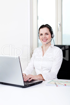 smiling young female callcenter agent with headset