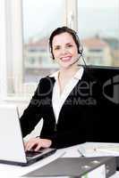 smiling young female callcenter agent with headset