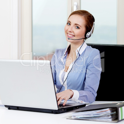 smiling young female callcenter agent with headset