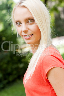 beautiful young blonde girl lying in grass summertime