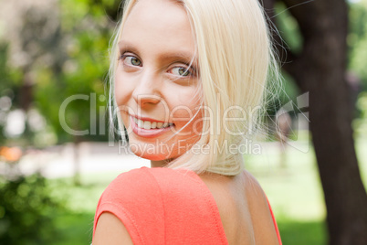 beautiful young blonde girl lying in grass summertime