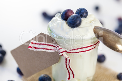 Jar of clotted cream or yogurt with blueberries