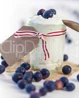 Jar of clotted cream or yogurt with blueberries