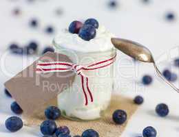 Jar of clotted cream or yogurt with blueberries