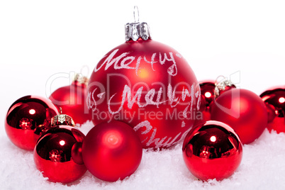 christmas decoration festive red bauble in snow isolated