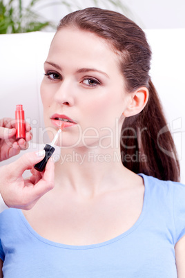 woman applying lipstick on lips natural beauty