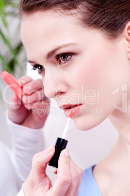 woman applying lipstick on lips natural beauty