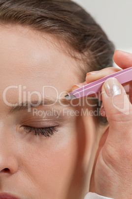 young beautiful woman eyebrow plucking tweezers eyes hair