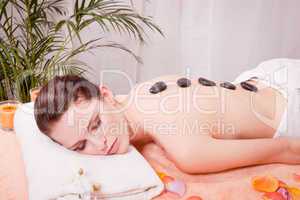 young attractive woman get hot stone massage