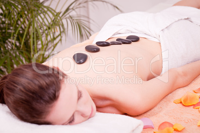 young attractive woman get hot stone massage