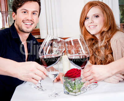 couple drinking red wine in restaurant