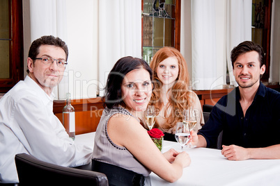 smiling happy people in restaurant