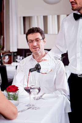 couple drinking red wine in restaurant