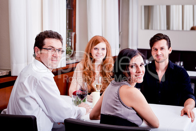 smiling happy people in restaurant