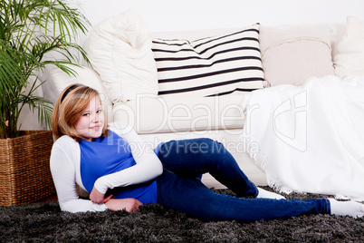 happy teenager girl smiling sitting on couch