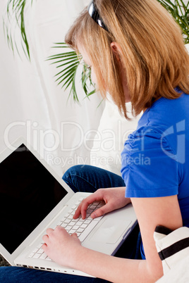 young teenager girl with laptop smilig