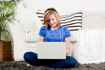 young teenager girl with laptop smilig