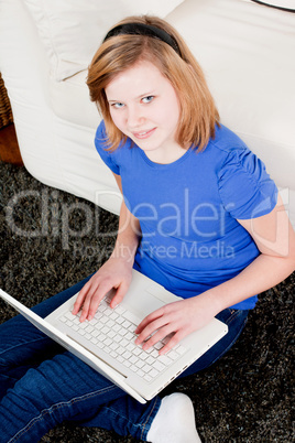 young teenager girl with laptop smilig