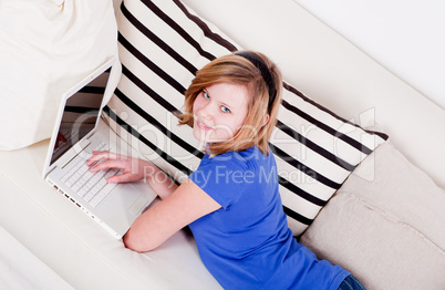 young teenager girl with laptop smilig