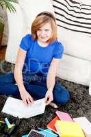 happy teenager girl doing homework