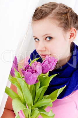 smiling teenager girl with pink tulips bouquet