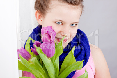 smiling teenager girl with pink tulips bouquet
