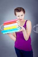 Silly smiling schoolgirl with glasses and lots of books