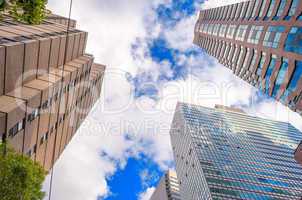 Bottom-Up view of office buildings against blue sky