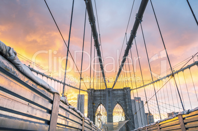 Magnificent structure of Brooklyn Bridge with sunset sky - NYC