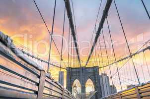 Magnificent structure of Brooklyn Bridge with sunset sky - NYC