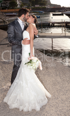 Married couple while kissing near the sea