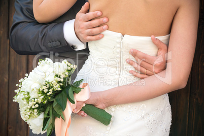 Married couple embraced, detail of the bust and arms
