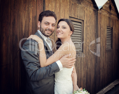 Married couple near wooden cabins