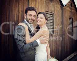Married couple near wooden cabins