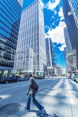 NEW YORK CITY - JUNE 12, 2013: Locals and tourists walk along ci