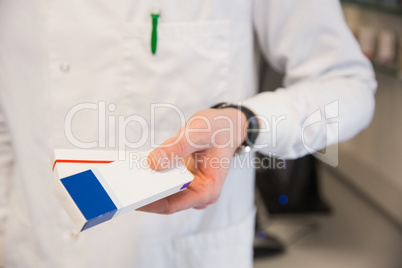 Pharmacist holding medicine boxes