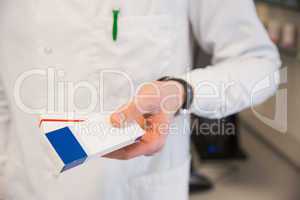 Pharmacist holding medicine boxes