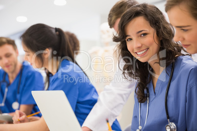 Medical student smiling at the camera during class