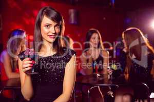 Pretty brunette drinking a cocktail