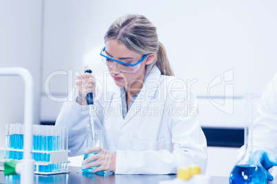 Science student using pipette in the lab