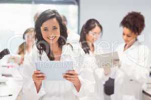 Science student holding tablet pc in lab