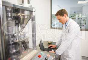 Focused pharmacist using his laptop