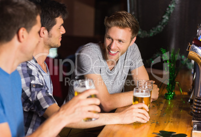 Happy friends catching up over pints