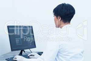 Female dentist looking at x-ray on computer