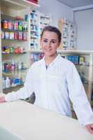 Portrait of a smiling student in lab coat looking at camera