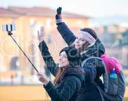 PISA, ITALY - JANUARY 6, 2015: Two happy famale young tourists p