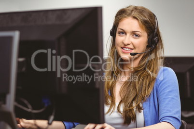 Student sitting at the computer room wearing headset