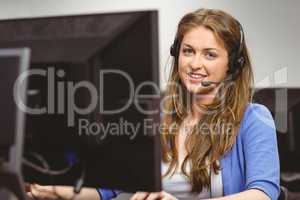 Student sitting at the computer room wearing headset