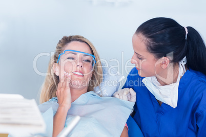 Dentist speaking with patient about toothache